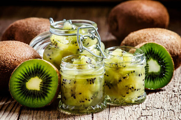Homemade kiwi jam, vintage wooden background, selective focus